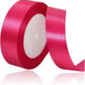 Roll of red ribbon with text indicating length on a white background